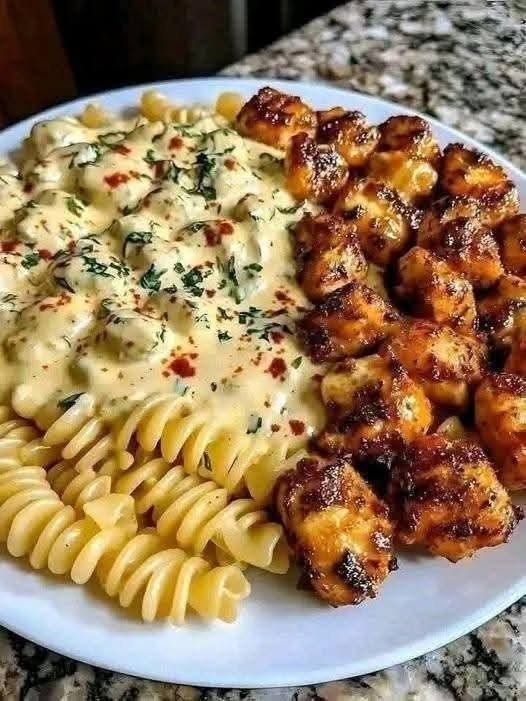 GARLIC BUTTER CHICKEN BITES & SPICY CAJUN ALFREDO TWISTED PASTA